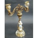 A GILT METAL, GLASS AND MEISSEN PORCELAIN TWO BRANCH CANDELABRA, the Meissen figure of a putti