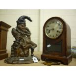 A CAST 'PUNCH' DOORSTOP, and a mantel clock (key and pendulum)