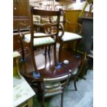 A MAHOGANY EXTENDING PEDESTAL DINING TABLE, with one extra leaf and six chairs including two carvers