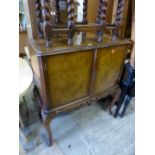 A WALNUT TWO DOOR DRINKS CABINET