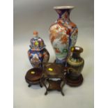 A JAPANESE IMARI VASE AND COVER, of hexagonal shape, together with an Imari baluster vase and a late