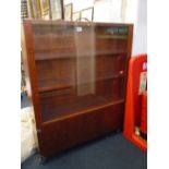 A WOODEN THREE SHELF PORTABLE DISPLAY CASE, with detachable wheeled storage unit to bottom, height