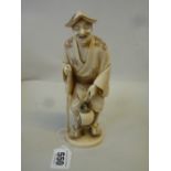 A JAPANESE CARVED IVORY FIGURE OF A STREET VENDOR, Meiji period, possibly Tokyo School, modelled