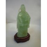 A CHINESE CARVED BOWENITE FIGURE OF A MONK, 20th Century, modelled standing and holding a ruyi