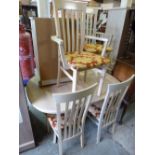 A MODERN EXTENDING DINING TABLE, and six chairs including two carvers