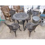 A CAST IRON CIRCULAR GARDEN TABLE, and four chairs