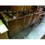 A WALNUT SIDEBOARD, with three central doors