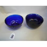 TWO CHINESE BLUE GLASS BOWLS, in the 18th Century manner but probably Republic, plain rounded form