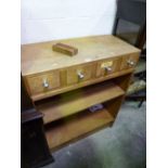 A LIGHT OAK OPEN BOOKCASE, with four small drawers to the top