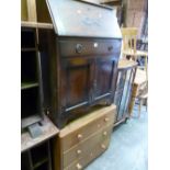 A SLIM OAK BUREAU, and a light oak chest of three drawers (2)