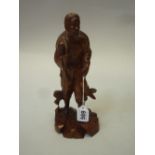 A JAPANESE ROOTWOOD CARVED FIGURE OF A FISHERMAN, 20th Century, modelled standing in rustic garb, he