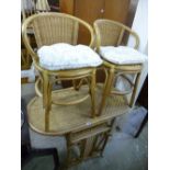 A WICKER TABLE, and two chairs (3)