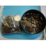 A ROUND TIN CONTAINING WORLD COINS