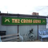 A LARGE WALL MOUNTED SIGN, The Cross Guns