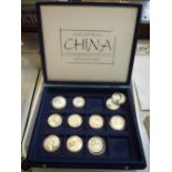 A BOX OF OFFICAL CHINA COIN COLLECTION, containing eleven silver coins, some from the compass