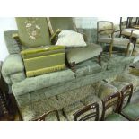 AN UPHOLSTERED THREE SEATER SETTEE