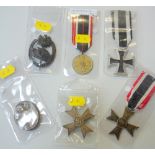 A GROUPING OF SIX WWII 3RD REICH MEDALS AND BADGES, consisting of War Merit medal and ribbon, War