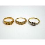 THREE RINGS, the first a 9ct gold diamond band ring, the second an 18ct gold three stone diamond