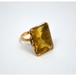 A DRESS RING, with large rectangular shape citrine, with rope twist detail to the bevelled shank,