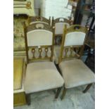 A SET OF FOUR EDWARDIAN OAK FRAMED DINING CHAIRS