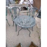 A MODERN HEAVY METAL CIRCULAR GARDEN TABLE, with two chairs (3)