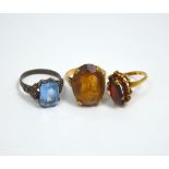 THREE DRESS RINGS, to include a 9ct gold citrine ring, a garnet cluster ring and a blue paste ring