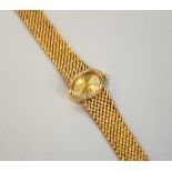 A LADIES 9CT GOLD DIAMOND WATCH, with oval shape face within a surround of single cut diamonds to