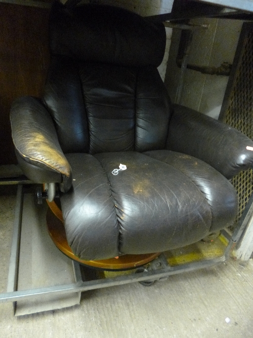 A LEATHER SWIVEL RECLINING ARMCHAIR