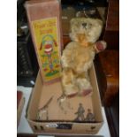 A MID 20TH CENTURY GOLDEN PLUSH MUSICAL TEDDY BEAR, jointed body, winding mechanism to back,