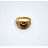 A 9CT GOLD RING, with central garnet to the fancy tapered sides, hallmarks for Birmingham, ring size