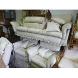 AN UPHOLSTERED FOUR PIECE SUITE, comprising of a three seater settee and a pair of armchairs and