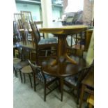 A MAHOGANY CIRCULAR EXTENDING DINING TABLE, and four chairs and another circular table and two