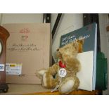 A BOXED STEIFF 100 YEARS TEDDY BEAR WITH BOOK, 23cm tall, with 100 Years Porcelain pendant and