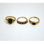 THREE 9CT GOLD RINGS, the first a hematite signet ring, together with a sapphire band ring and a