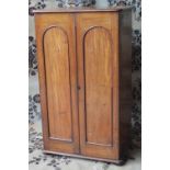 A VICTORIAN MAHOGANY COLLECTORS CABINET, the twin arch panelled doors revealing twelve glass