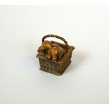 AN AUSTRIAN BRONZE GROUP OF TWO DACHSHUNDS IN A BASKET, approximate height 4.5cm