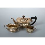 A LATE VICTORIAN SILVER THREE PIECE TEASET, stop fluted decoration, Jones and Crompton, Chester