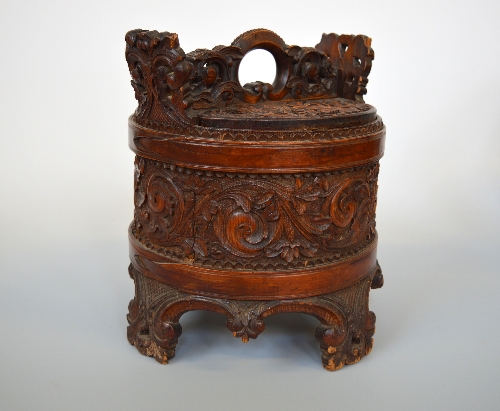 A NORWEGIAN BIRCH AND PINE DRY STORAGE BOX AND COVER, of cylindrical form, carved scrolling