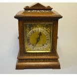 AN OAK CASED MANTLE CLOCK, gilt brass dial with silvered chapter, fast/slow and chime/silent