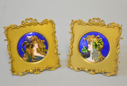 A PAIR OF CONTINENTAL ENAMELLED PLAQUES, profile bust portraits of maidens on a rich blue ground,