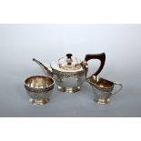 A GEORGE V SILVER THREE PIECE TEA SET, hammered and rope twist decoration, Albert Edward Jones,