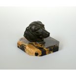 A MARBLE PAPERWEIGHT, mounted with a patinated cast metal head of a Dachshund, approximate height