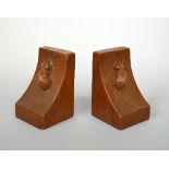 A PAIR OF ROBERT MOUSEMAN THOMPSON OAK BOOKENDS, carved with a single large mouse to each end,