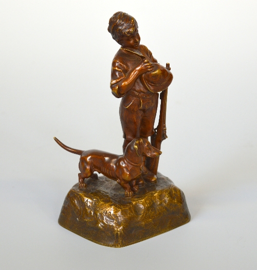 AFTER A. WERNER, young boy with a rifle, a Dachshund at his feet, patinated bronze, approximate