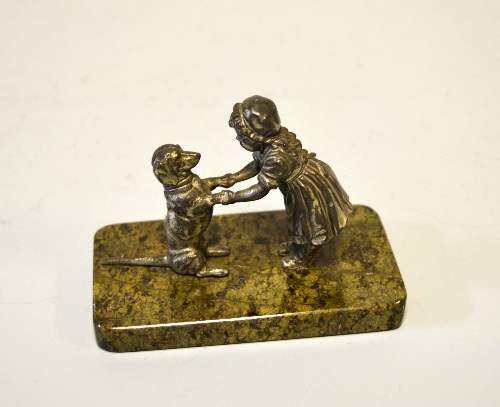 AN AUSTRIAN SILVERED GROUP OF A GIRL AND BEGGING DACHSHUND, on a marble base, height approximately