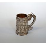 A CHINESE WHITE METAL TANKARD, chased figural decoration and dragon handle, GW and character mark,