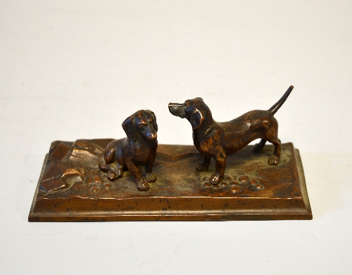 A FRENCH BRONZE GROUP OF TWO DACHSHUNDS, on a rectangular stoney base, height approximately 14.5cm