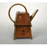 AN ARTS & CRAFTS COPPER AND BRASS KETTLE AND BURNER, in the manner of Christopher Dresser, of