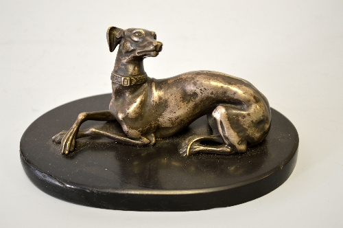 A FRENCH SILVERED FIGURE OF A RECUMBENT GREYHOUND, an oval marble base, height approximately 16cm