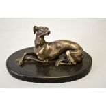 A FRENCH SILVERED FIGURE OF A RECUMBENT GREYHOUND, an oval marble base, height approximately 16cm